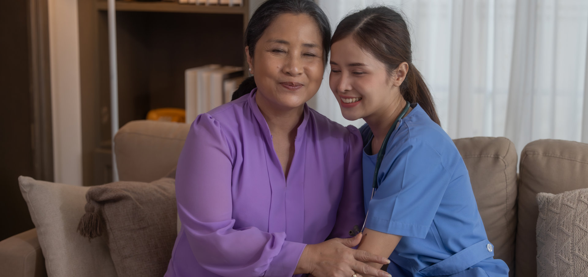 Two women sitting together and smiling