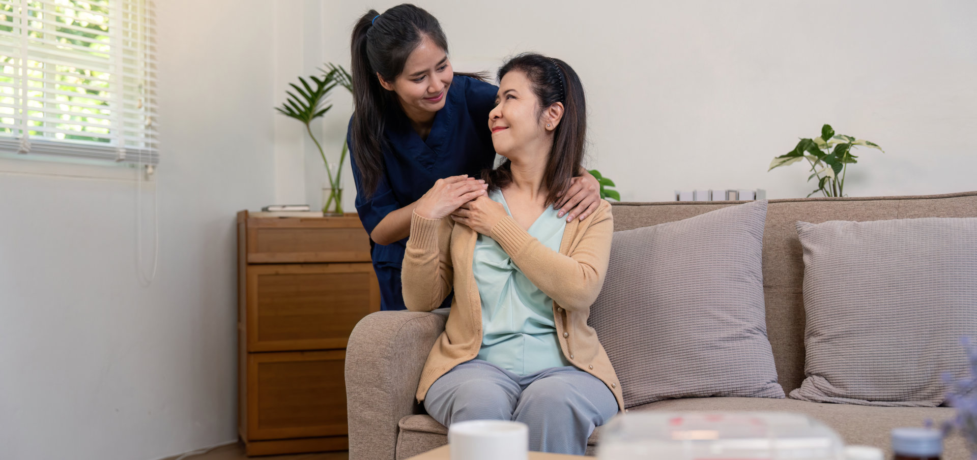 A woman giving a shoulder massage to another woman