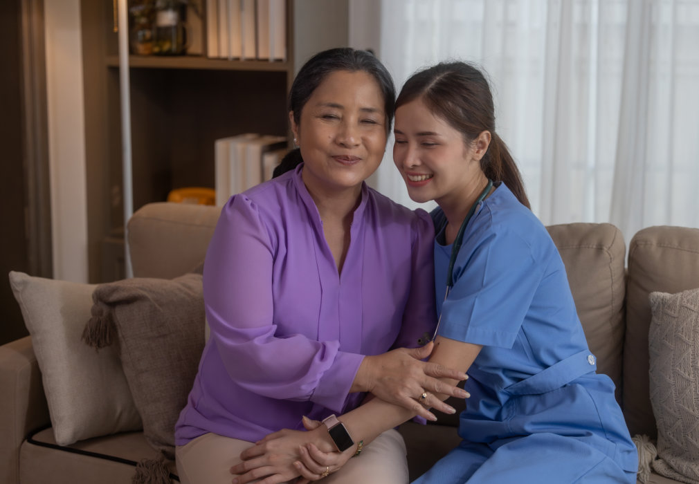 Two women sitting together and smiling